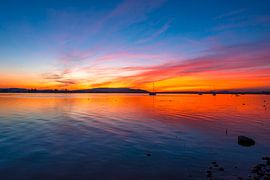 A dramatic sunset over Lake Constance with a view of the Hegau Volcanoes