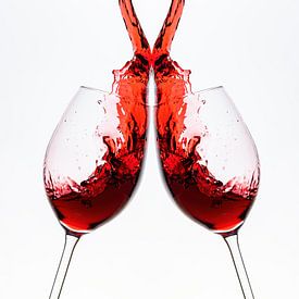 Red wine flows into the wine glass by Roland Brack