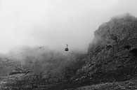 Zwart-wit beeld van kabelbaan in de mist van de Tafelberg in Zuid-Afrika von Romy Wieffer Miniaturansicht