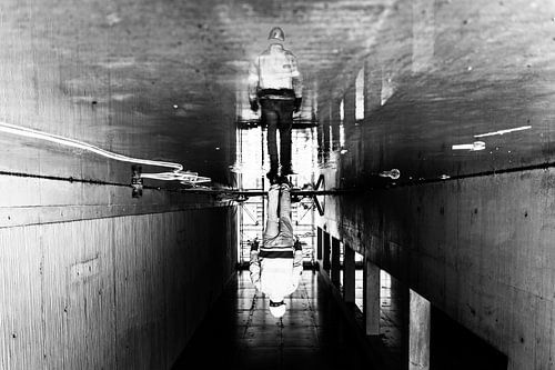 Reflection in the water of a construction worker