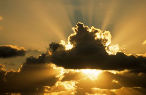 Sun rays beam from behind cumulus clouds by Nature in Stock