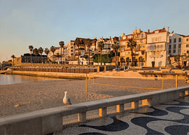 Seaside Morning in Cascais, Portugal with Fisherman Huts and Lone Seagull by Hecate Pim