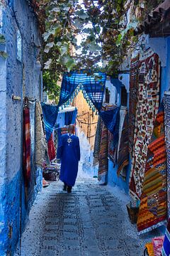 A man walks through the streets of Chefchaouen by Rene Siebring