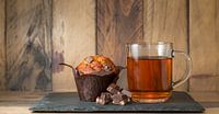 Cup of tea with a muffin and chocolate