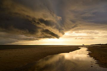 Sunrise at the beach at Texel island with a storm cloud approaching