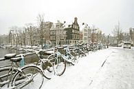 Snowy bikes on the canals in Amsterdam in winter by Eye on You thumbnail
