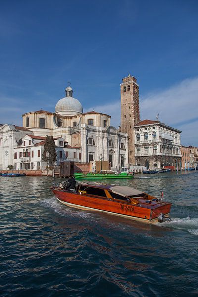 Wooden speedboat on canal in old town of Venice, Italy by Joost Adriaanse