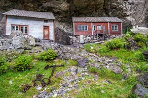 Cottages built under rock shelter in Norway
