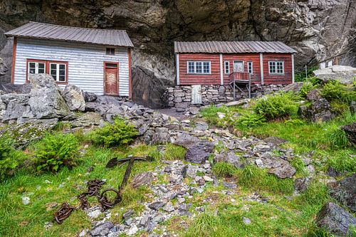 Cottages built under rock shelter in Norway