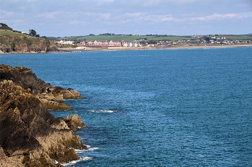 Coastal Serenity with Cliffs and Distant Townscape