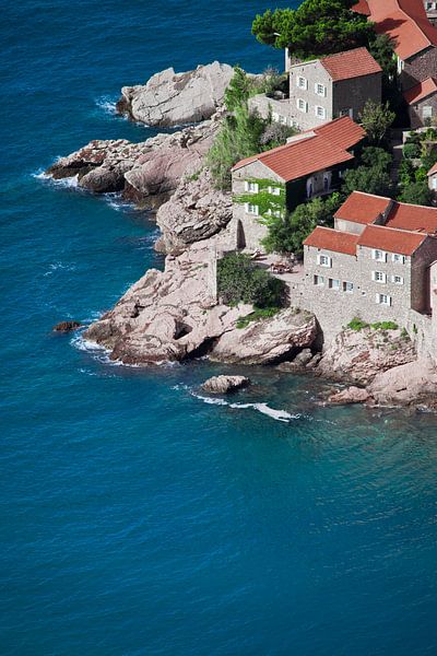 Old houses are an ideal hotel. small houses with a tiled roof and green trees by the blue sea. happi by Michael Semenov