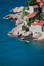 Old houses are an ideal hotel. small houses with a tiled roof and green trees by the blue sea. happi by Michael Semenov thumbnail