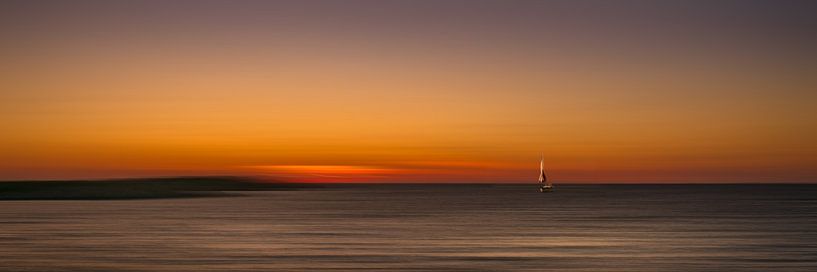 A lonely boat in the sunset by ahafineartimages
