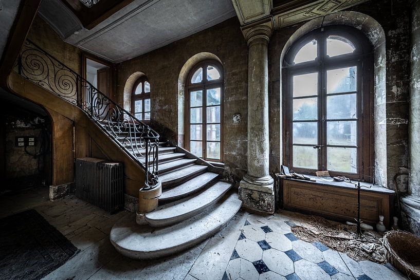 Stairs in large hall of abandoned villa by Inge van den Brande