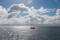 Sun over the Wadden Sea with sailing boat