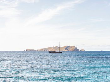 A sailboat lying in the deep blue Mediterranean Sea off Ibiza