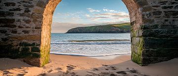 Vue sur la plage à travers une arche de pierre sur Poster Art Shop