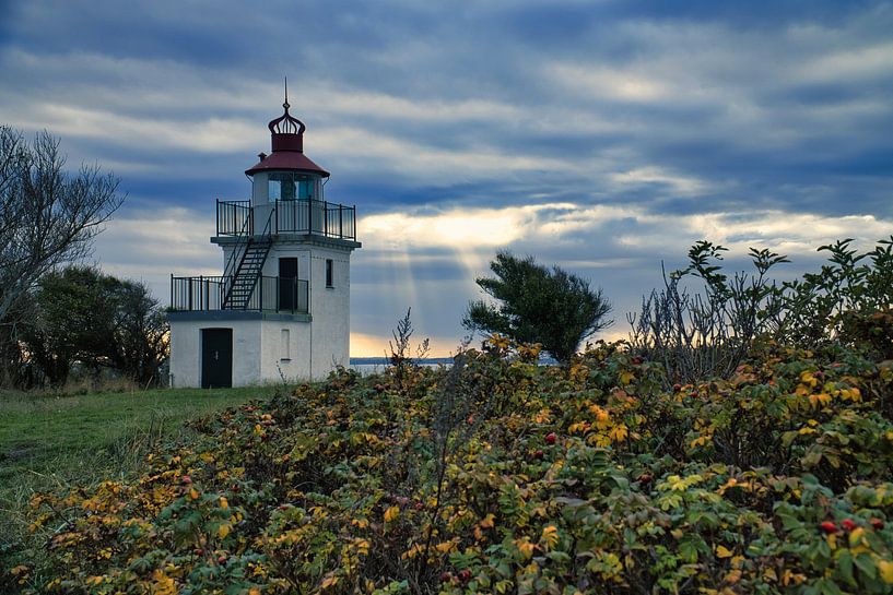 Lighthouse by the sea and rays of sunshine by Martin Köbsch