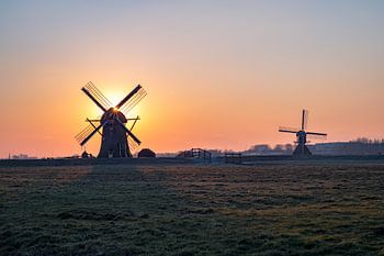 Two mills at sunset