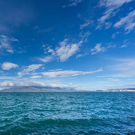 IJsland - Blauw water van de oceaan aan de kust van de stad reykjavik met bergen van adventure-photos