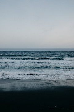 Black beach, blue sea and white waves in Tenerife by Yvette Baur