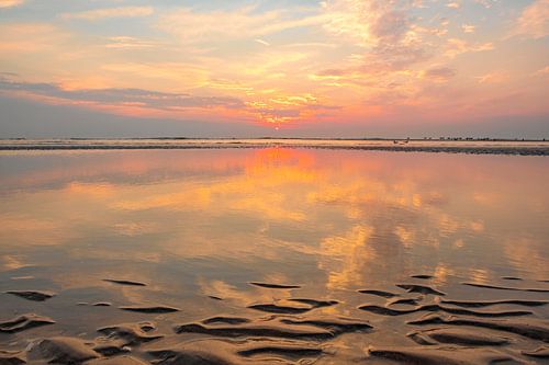 Zonsondergang op het Noordzeestrand met een golfpatroon in het zand