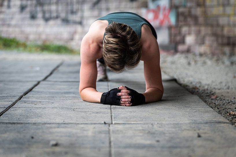 Active 36 year old white woman planking under a bridge outdoors, by Werner Lerooy