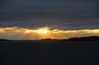 zon achter de wolken