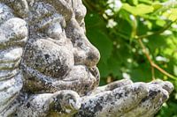 Weathered statue in garden