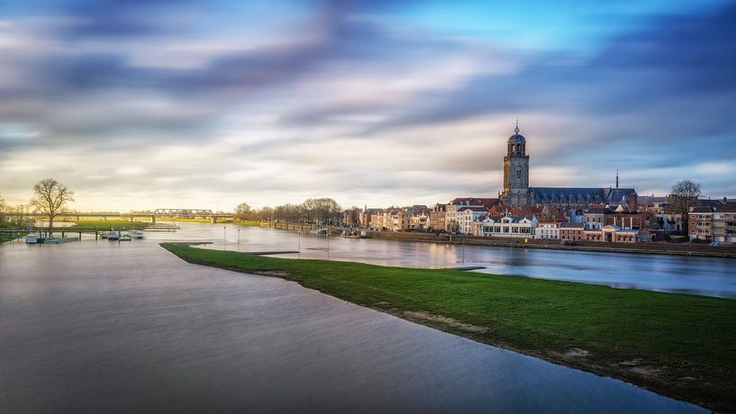 View of Deventer taken at long shutter time with beautiful clouds and the IJssle in the foreground by Bart Ros