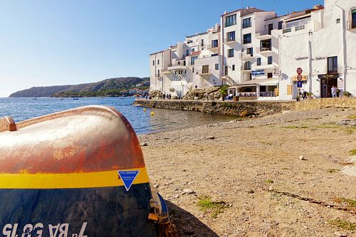 A fishing boat lies on the beach of Cadaqués.