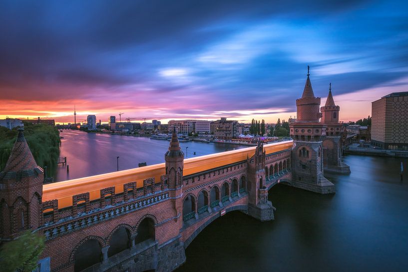 Berlin Oberbaumbrücke with subway at sunset by Jean Claude Castor