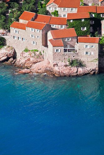 Old houses are an ideal hotel. small houses with a tiled roof and green trees by the blue sea. happi