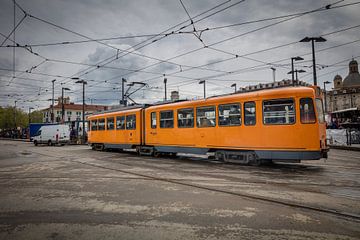 Orange tram in centre of Turin, Italy by Joost Adriaanse