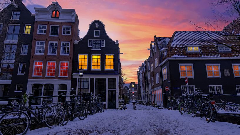Cityscape of snowy Amsterdam at sunset by Eye on You