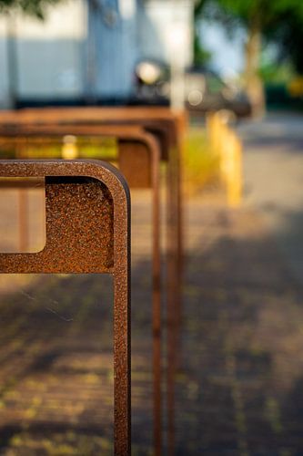 Rusty brown bike racks on the street