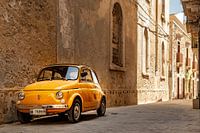 Oude gele Fiat 500 in Syracuse op Sicilië, Italië.
