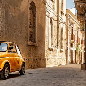 Old yellow Fiat 500 in Syracuse in Sicily, Italy. by Ron van der Stappen