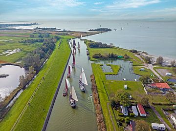 Aerial view of the sailing race the Workumer Strontrace with traditional old boats near Workum in the Netherlands by Eye on You