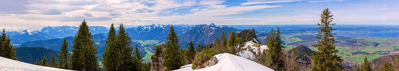 Panoramic view over the snow-covered Chiemgau mountains with forest and clear blue sky in the background of Lake Chiemsee in Bavaria by Thomas Heitz