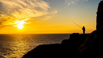 Fisherman during sunset in Peniche