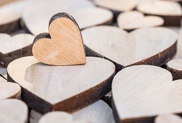 Romantic love background with close-up of many wooden hearts by Alex Winter