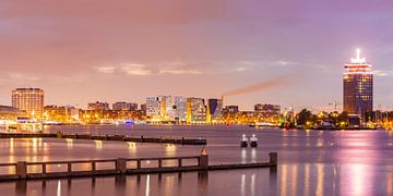 View over IJ river to Westerdok and IJDock in Amsterdam at night by Werner Dieterich