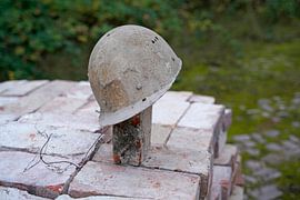 stacked bricks and old construction helmet on a building site