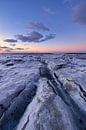 IJs bedekt de Waddenzee in de winter aan de Groningse Waddenkust tijdens zonsondergang. De ondergaan van Bas Meelker thumbnail