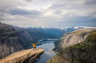 Trolltunga: The yellow man overlooking Ringedalsvannet and snow-capped mountains by Be More Outdoor thumbnail