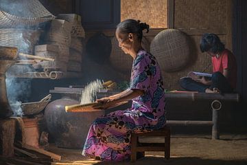 Sorting rice in the traditional way by Anges van der Logt
