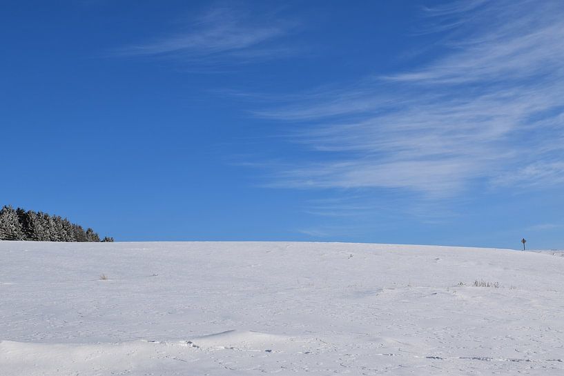 An area in winter under blue skies by Claude Laprise