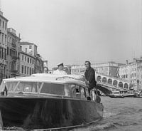 Scottish actor Sean Connery standing on a water taxi