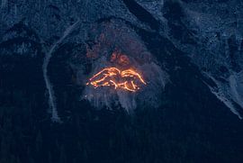 Traditional mountain fires over Ehrwald - impressive lines of light on the slopes of the Wetterstein, which bathe the Tyrolean mountains in a magical glow. An extraordinary motif of Alpine culture. by Miriam Schwarzfischer Fotografie